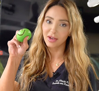 Picture of Dr Rhonda Kalasho holding green smiley ball